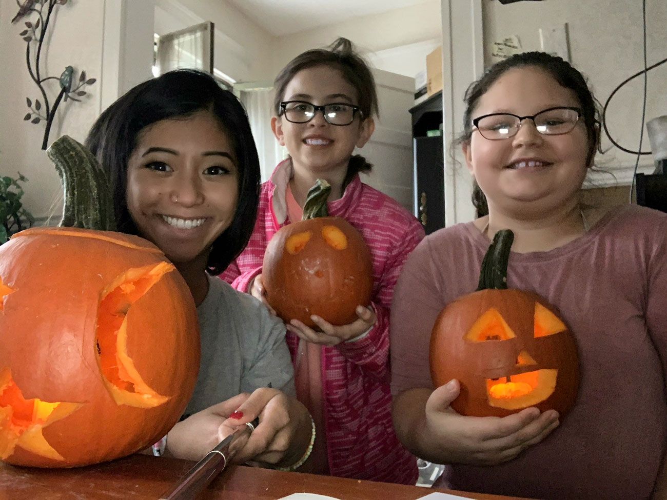 volunteer and kids with pumpkins