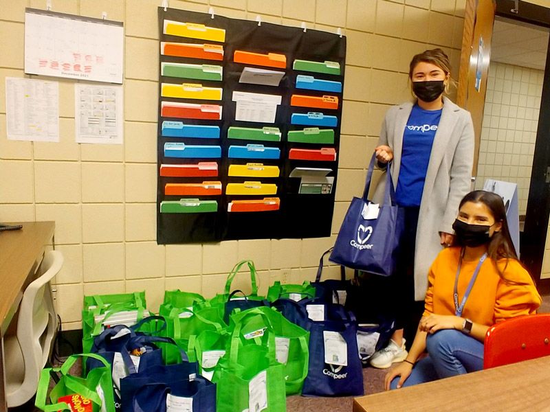 volunteers with an assortment of tote bags